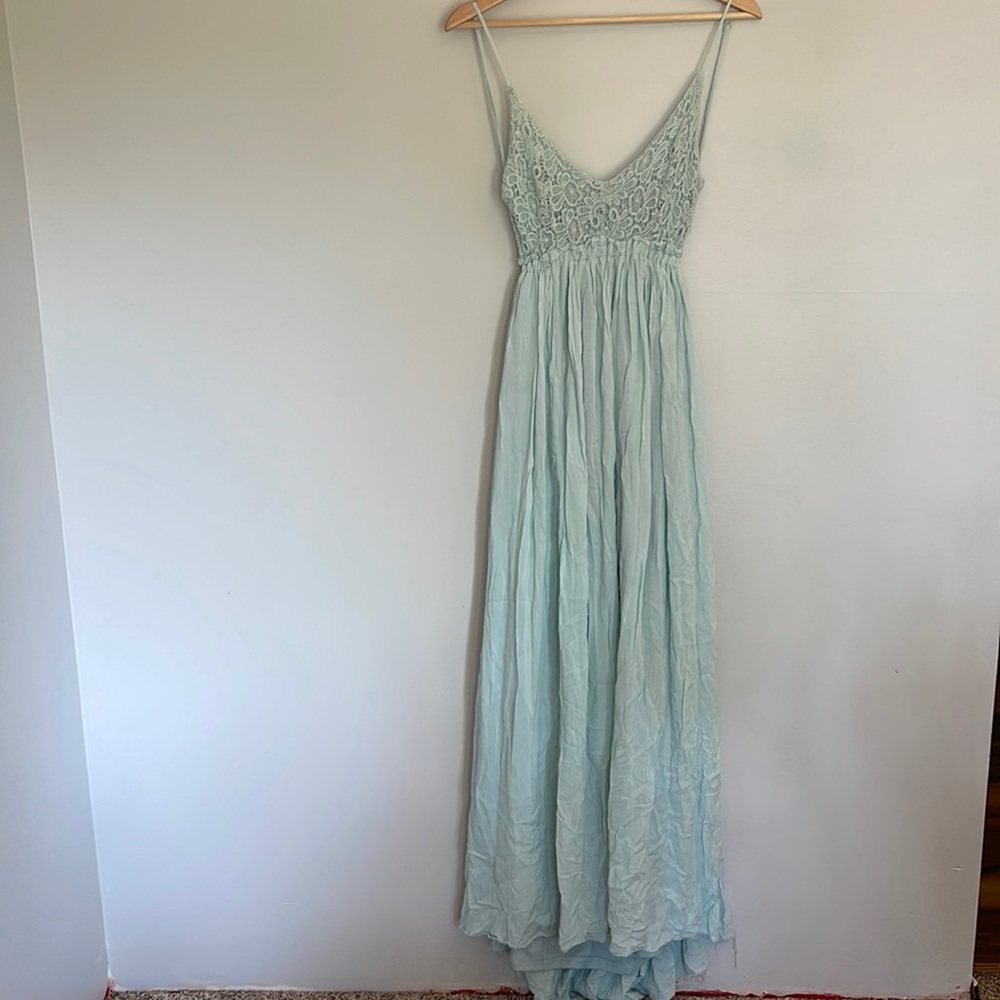 Crochet top maxi dress with open back and frayed hem.